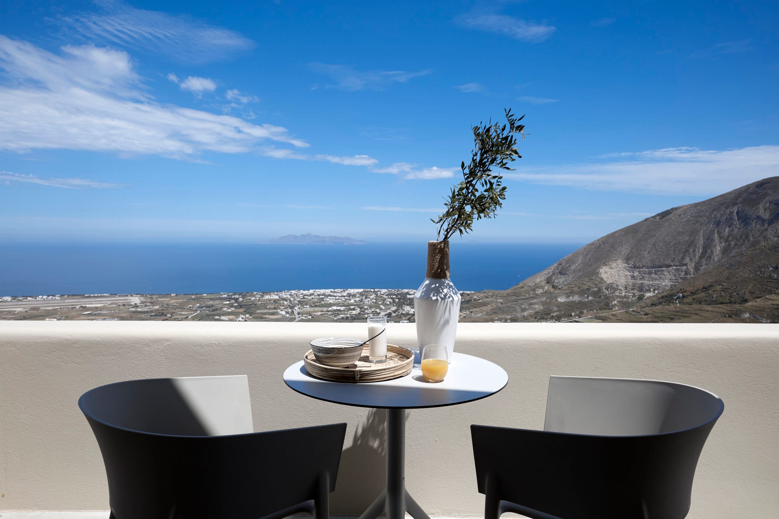 Breakfast for two on a Star Infinity Suites terrace overlooking the Aegean Sea and the mountains of Santorini